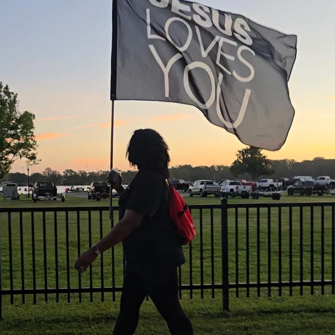 Silhouette with flag at sunset