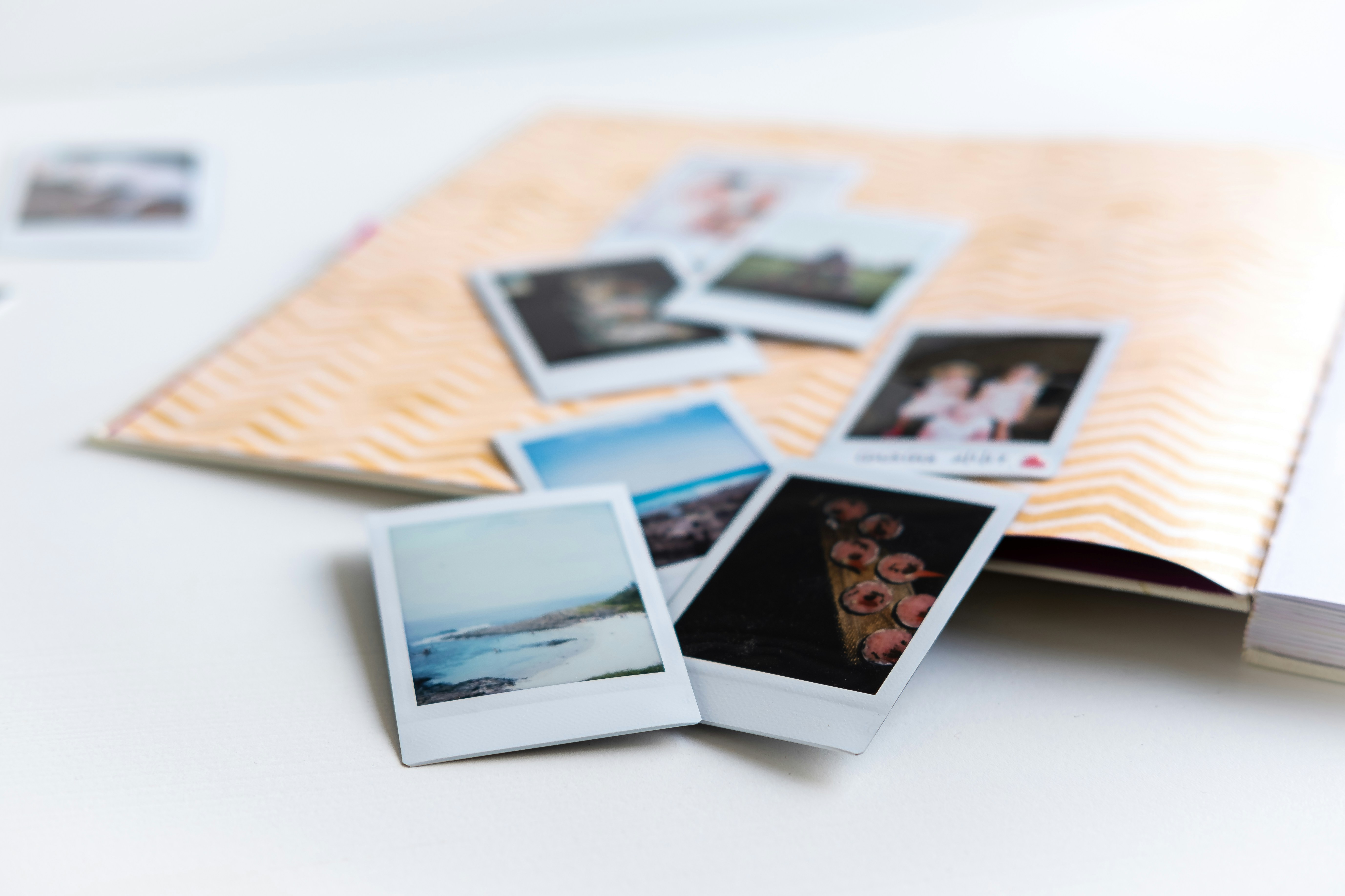 Scattered Polaroid photos on wooden surface